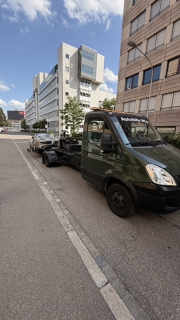 MILA Abschleppfahrzeug mit aufgenommenem Personenwagen im Stadtgebiet